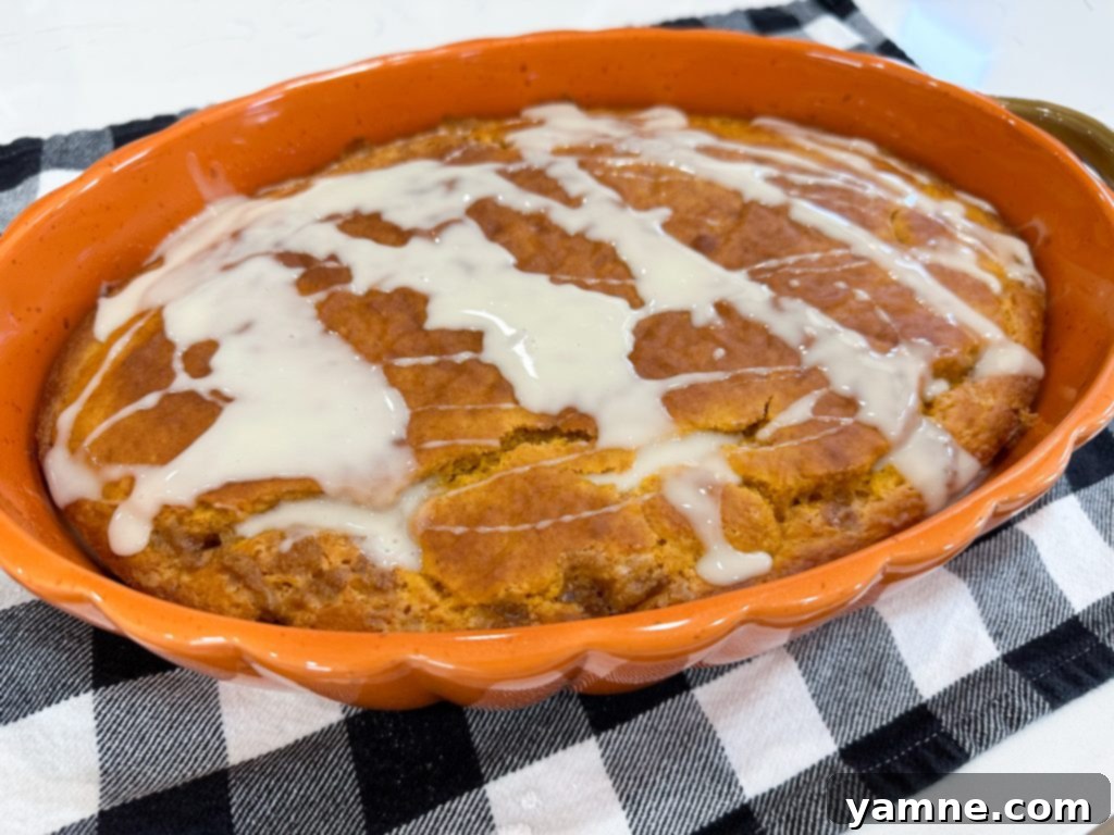Spiced Pumpkin Honey Bun Cake 8 Vanilla glaze mixture being whisked in a bowl.