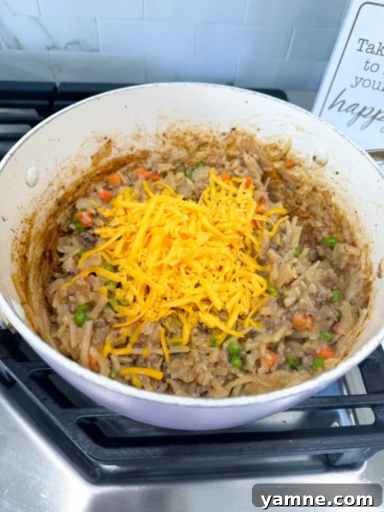 Loaded Cheeseburger Hash Brown Bake 4 cheeseburger hashbrown casserole with cheese stirred in