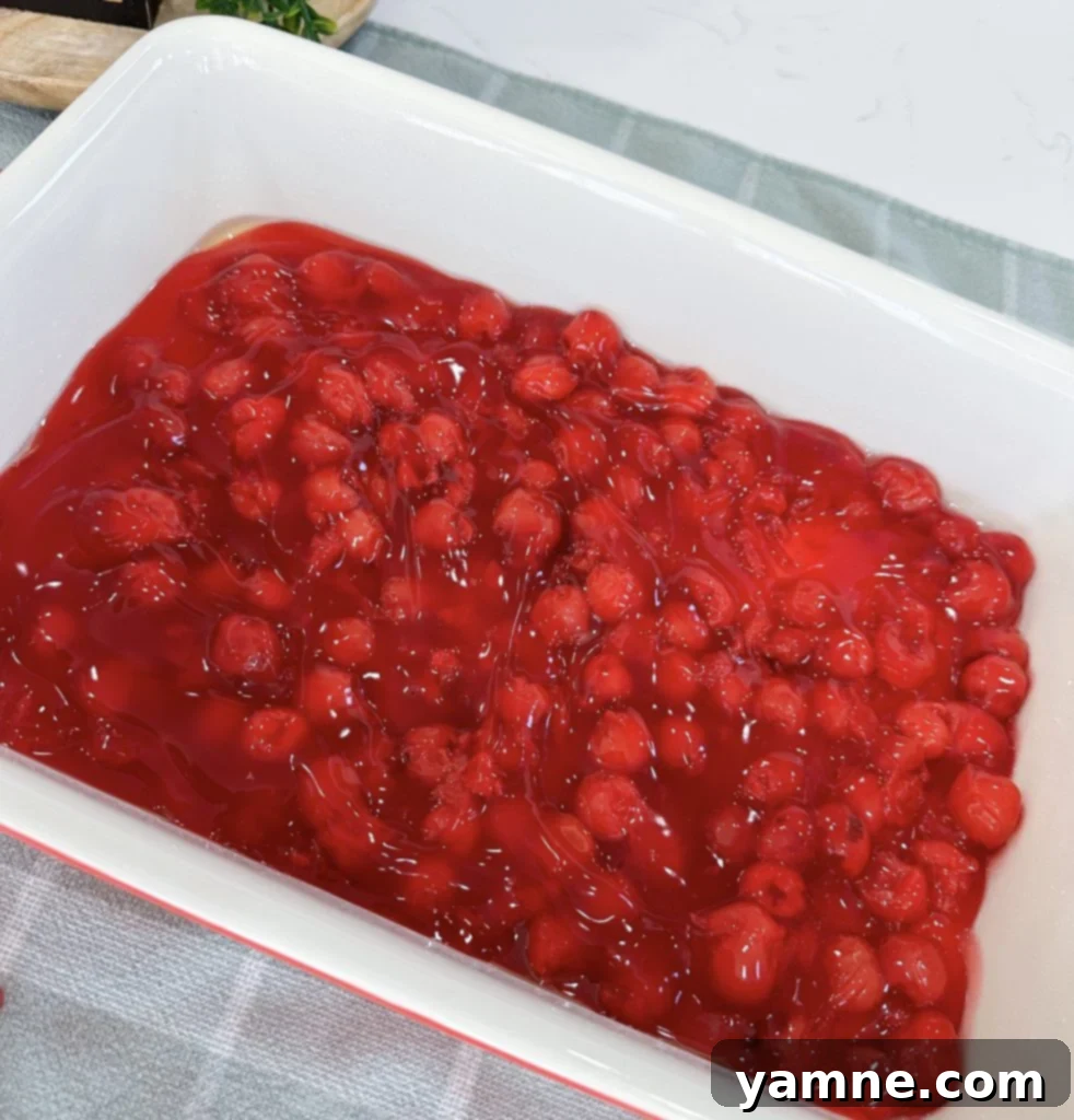 Cherry pie filling at the bottom of a baking dish