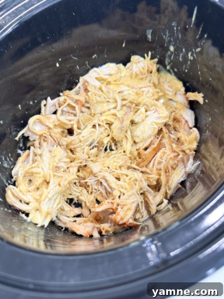 Juicy slow cooker honey mustard chicken coated in sauce