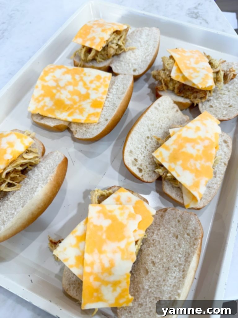 Shredded chicken ready for juicy slow cooker honey mustard sauce