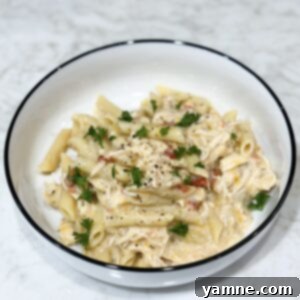 Slow cooker creamy chicken pasta topped with parsley