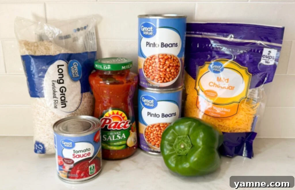 A colorful dish of Spanish rice with pinto beans, garnished with fresh cilantro and avocado slices.