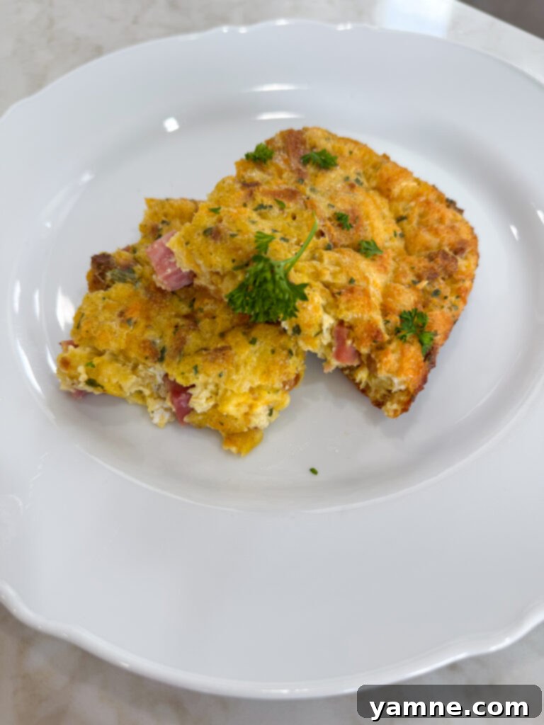 Close-up view of the Ham Stuffing Egg Casserole mixture in a bowl before baking, showing eggs, ham, cheese, and stuffing mix combined.