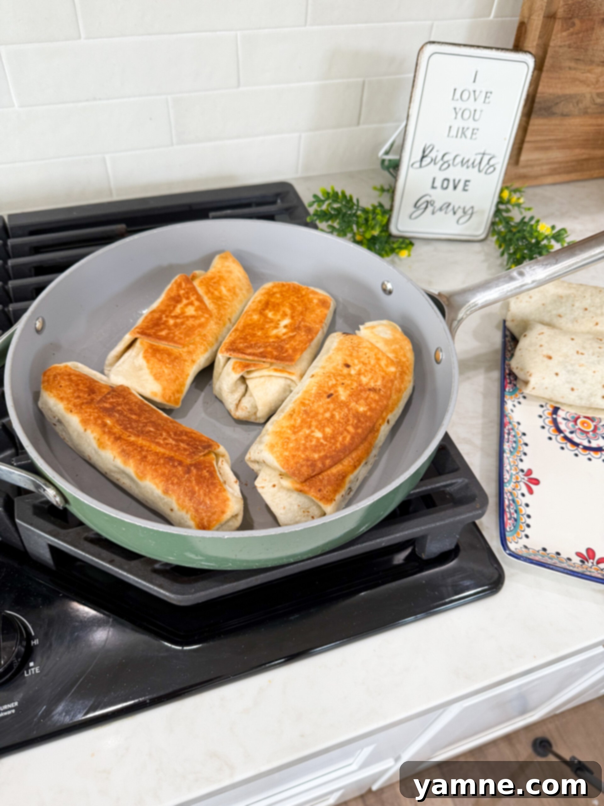 Hearty Lentil Potato Burritos 8 Golden-brown lentil and potato burritos crisping up in a hot skillet.