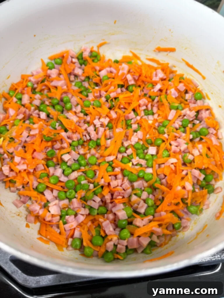 Tender veggies and ham sautéing
