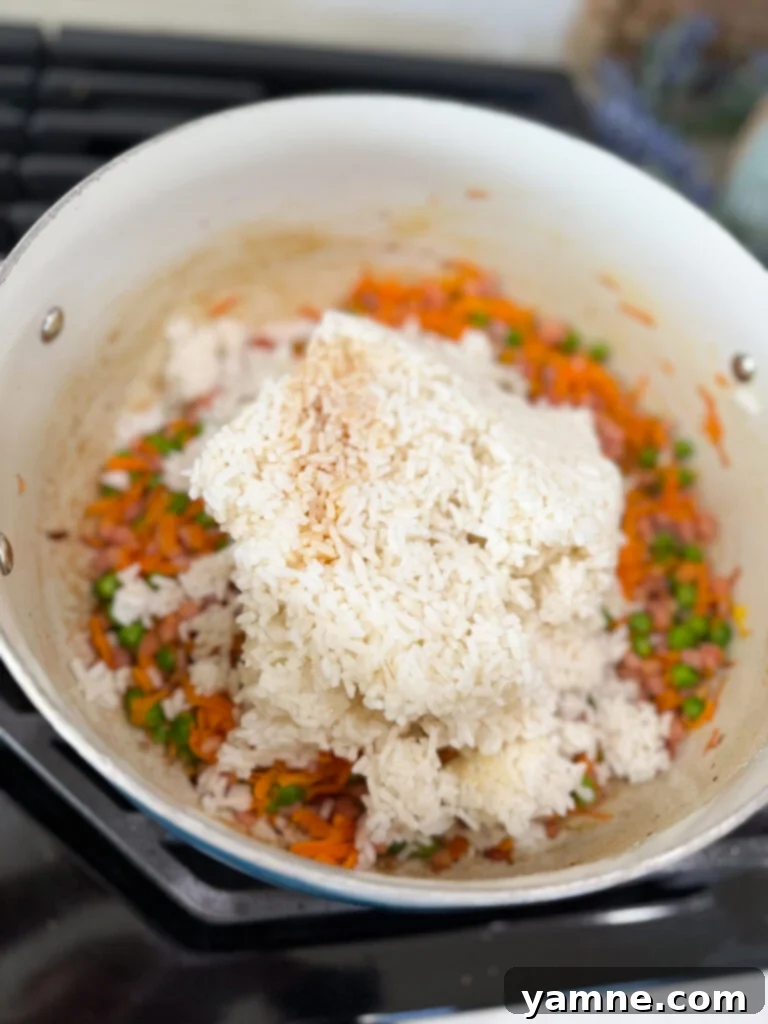 Adding cold rice to the sautéed veggies