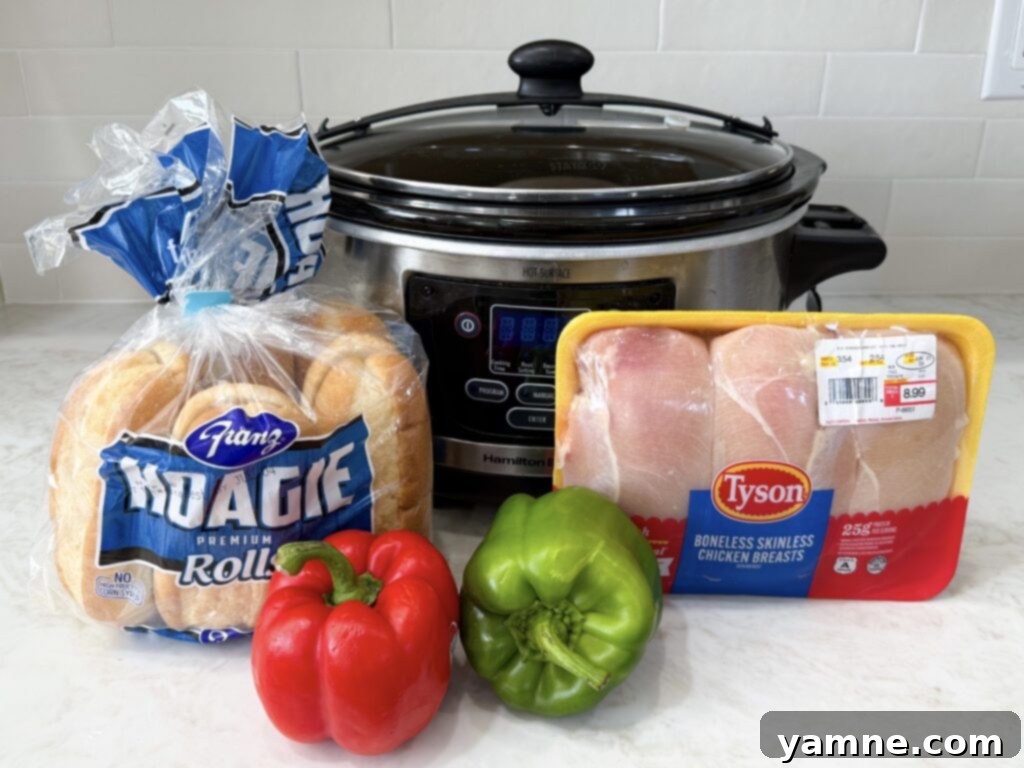 Fresh ingredients for Crockpot Chicken Philly Cheesesteak Sandwiches including chicken, peppers, onions, and cheese