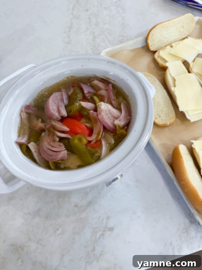 Tender chicken and vegetables after slow cooking for Philly cheesesteak