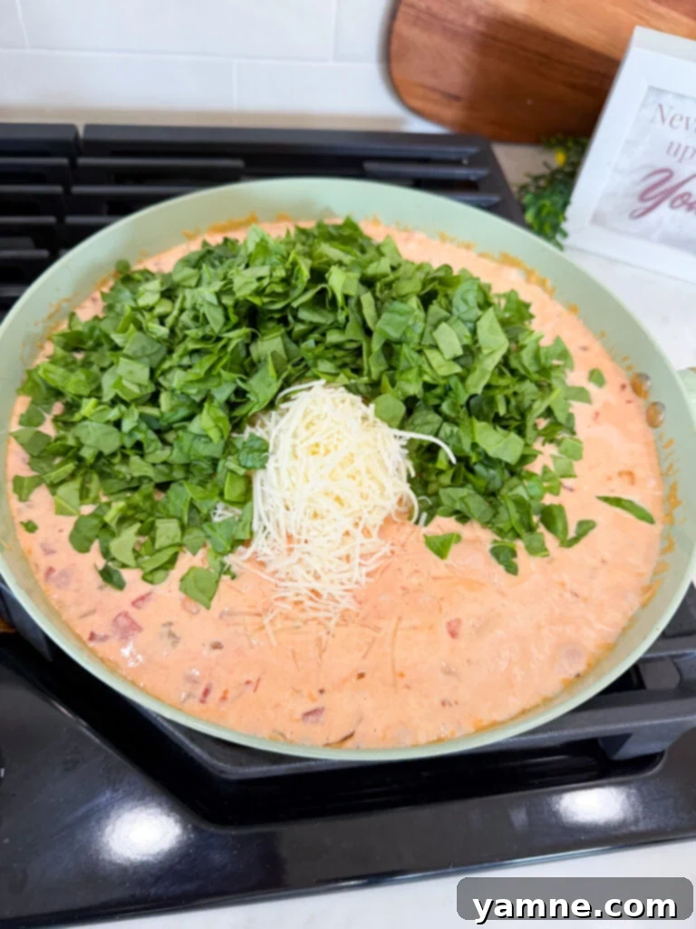 Italian Sausage Pasta in a Silky Cream Sauce 7 Adding Spinach to the Creamy Italian Sausage Sauce