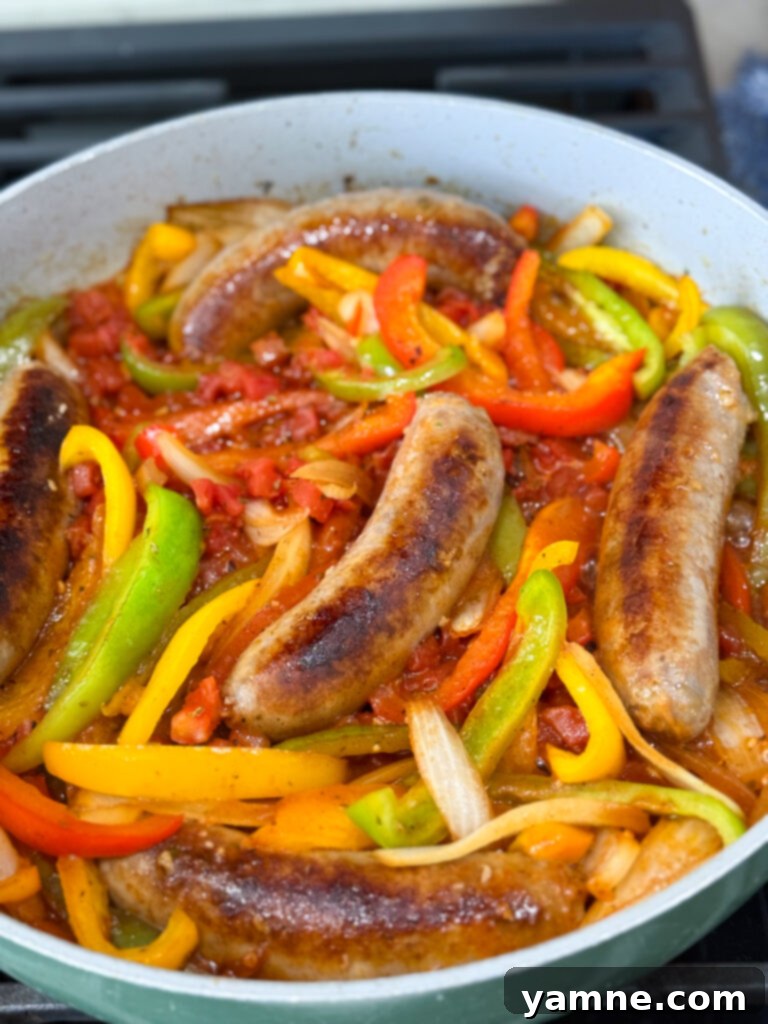 Sausages being added back to the pan