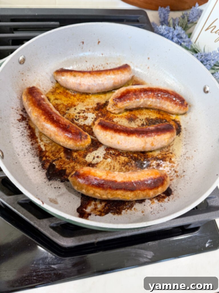 Cooking sausages in a pan