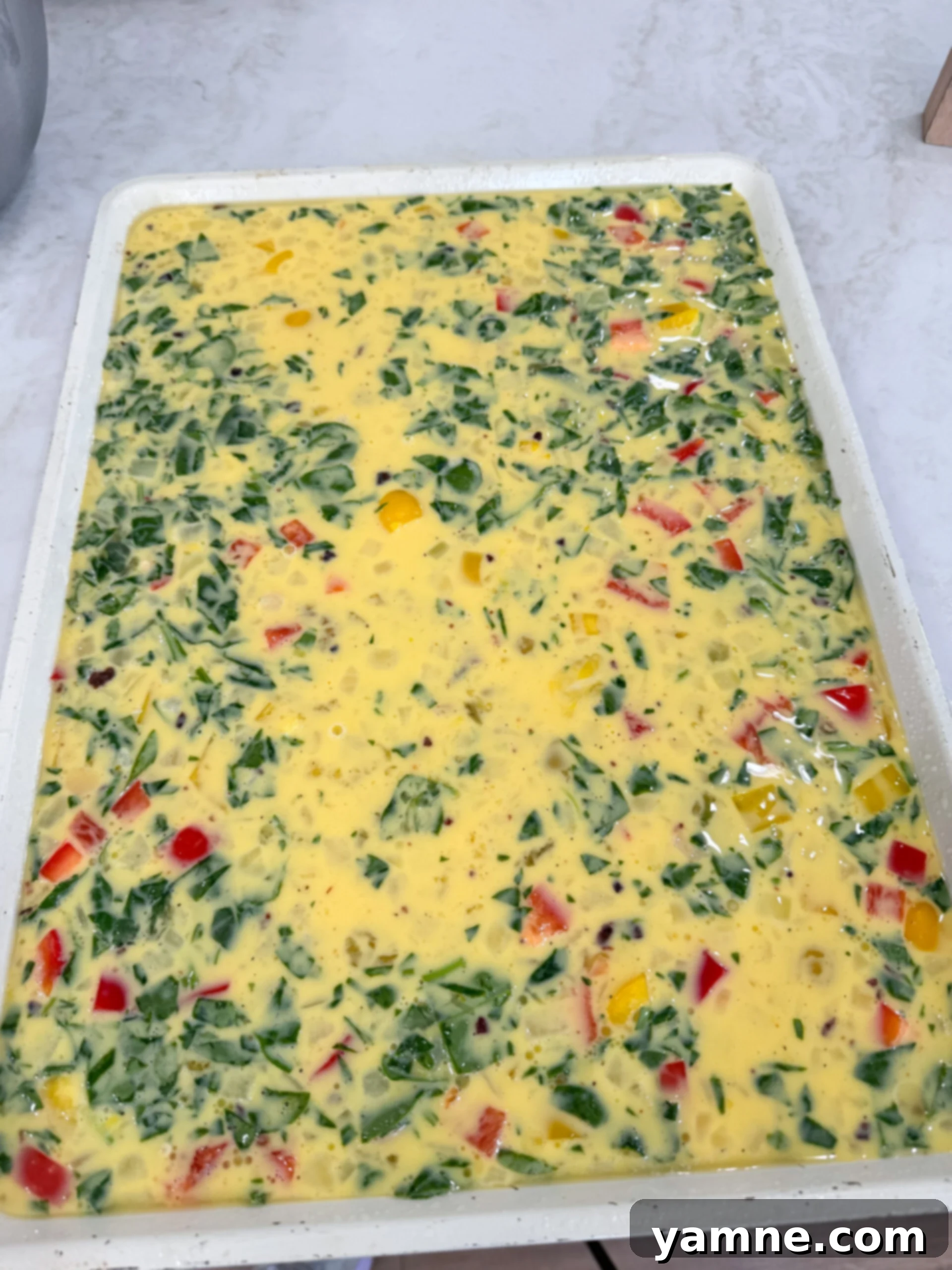 Sheet pan with cooked scrambled eggs.