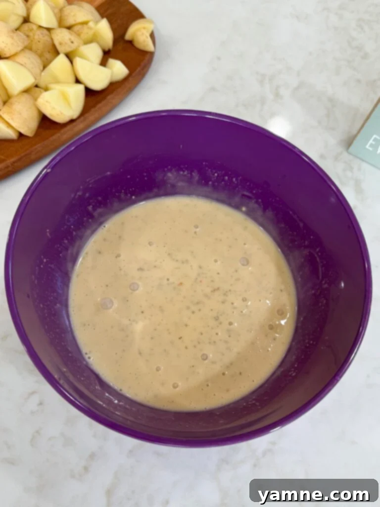 Comforting Slow Cooker Garlic Parmesan Chicken and Potatoes 8 Parmesan mixture in a purple bowl on a white counter