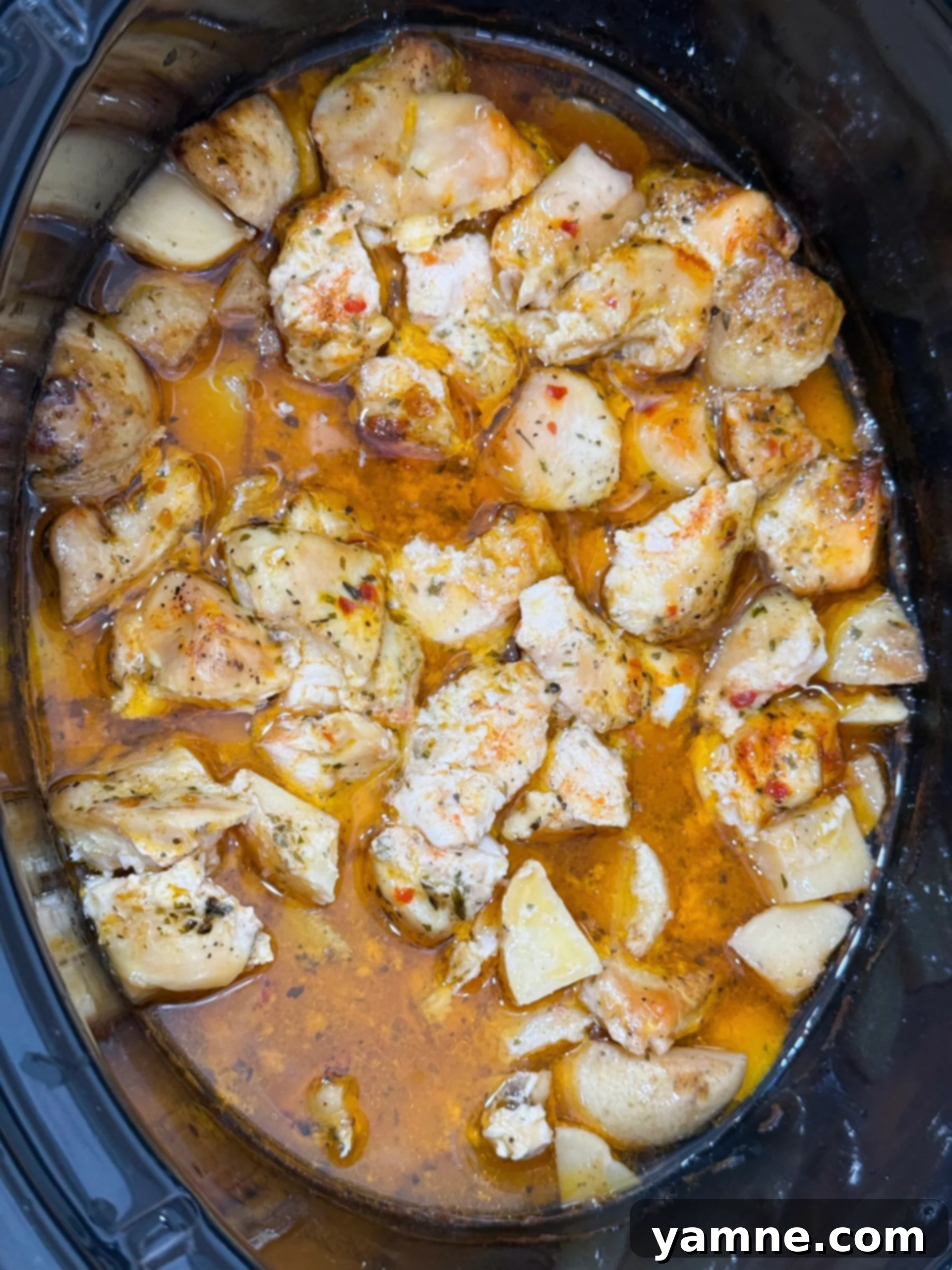 Comforting Slow Cooker Garlic Parmesan Chicken and Potatoes 9 Cooked chicken in a garlic parmesan sauce in the slow cooker