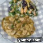 Comforting Slow Cooker Garlic Parmesan Chicken and Potatoes 12 chicken and potatoes on a blue and white plate with salad