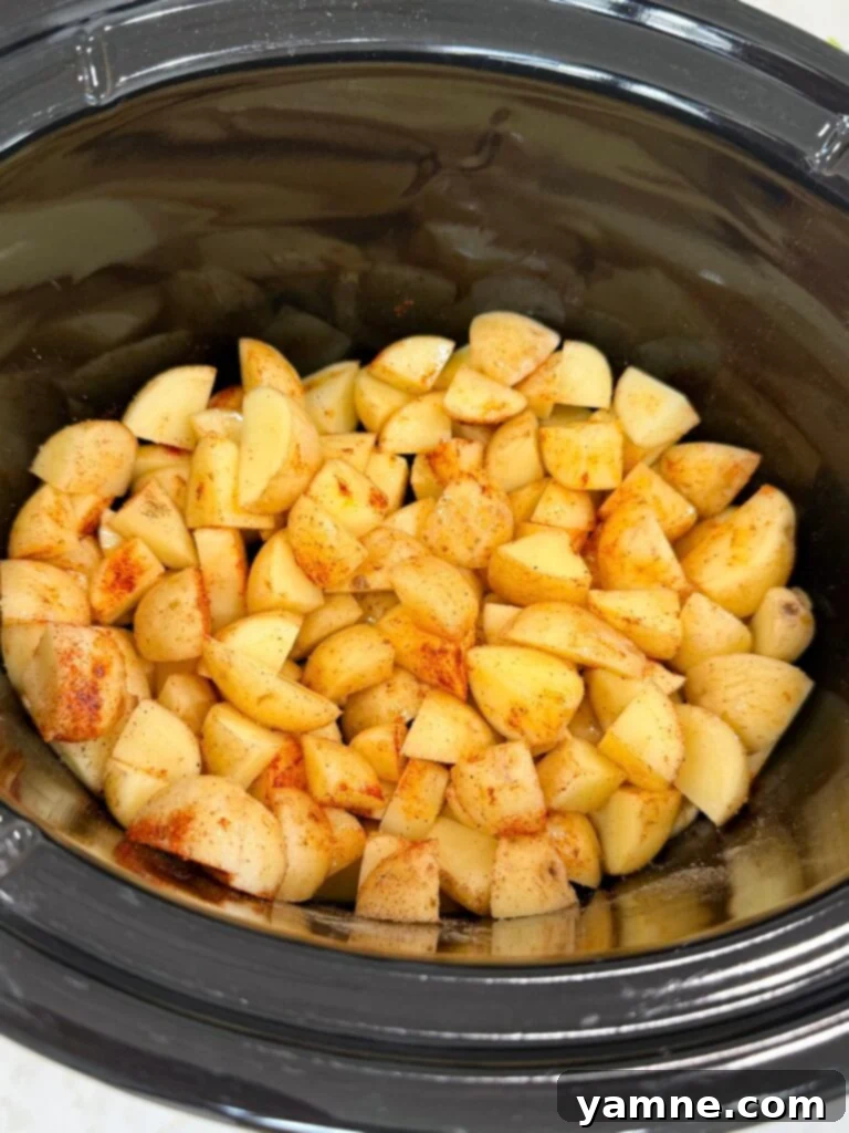 Comforting Slow Cooker Garlic Parmesan Chicken and Potatoes 5 Diced seasoned potatoes in a slow cooker