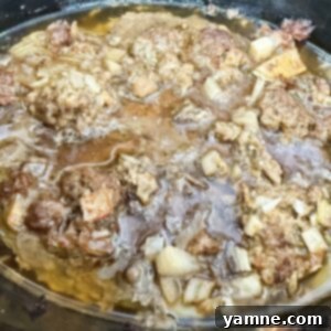 cooked ground meat in a black slow cooker, ready for serving or meal prep.