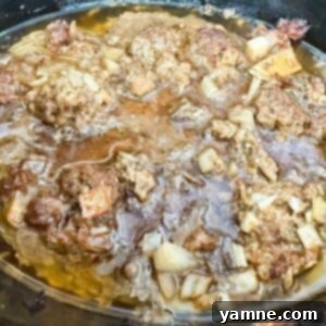 Ground meat cooked to perfection in a black slow cooker, ready for various uses.