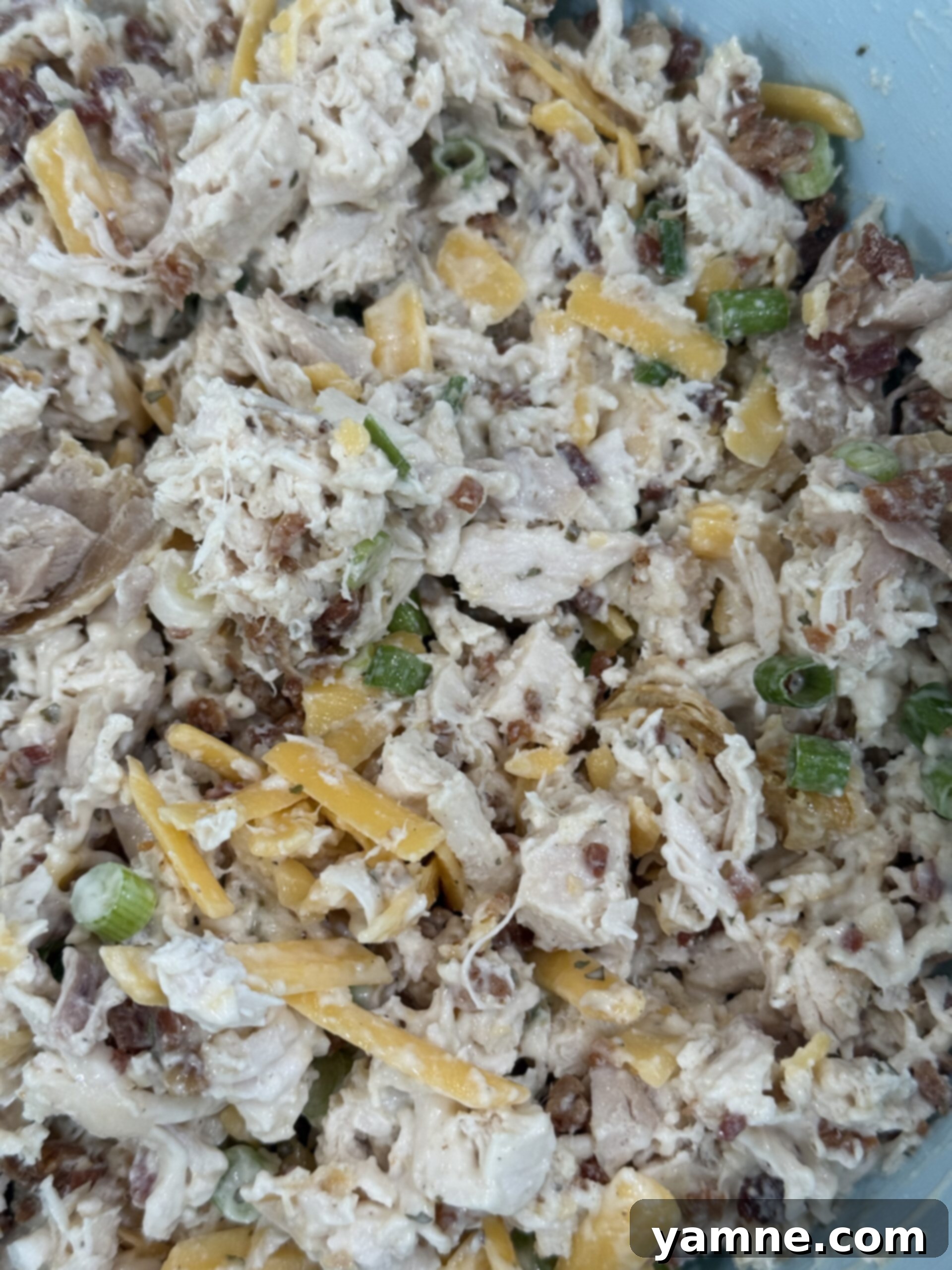 Completed Bacon Ranch Chicken Salad served in a bowl with a spoon