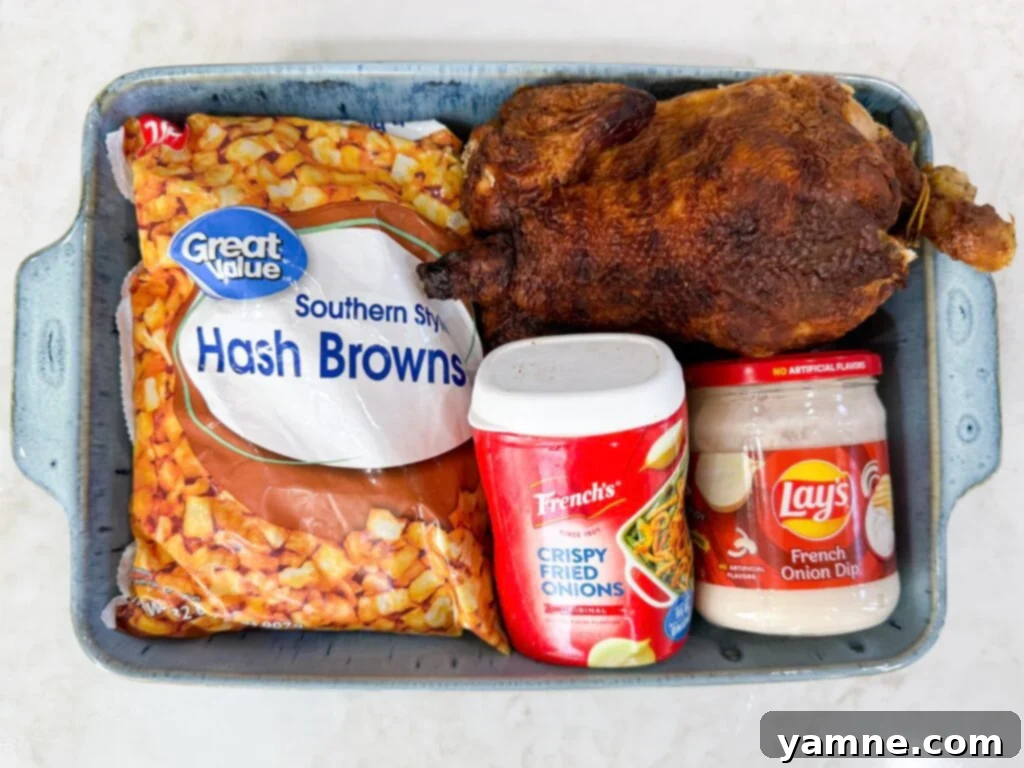 Cheesy French Onion Chicken Hash Brown Bake 4 Ingredients for Onion Chicken Potato Casserole including shredded chicken, hash browns, cheddar, French onion dip, cream soup, and fried onions.