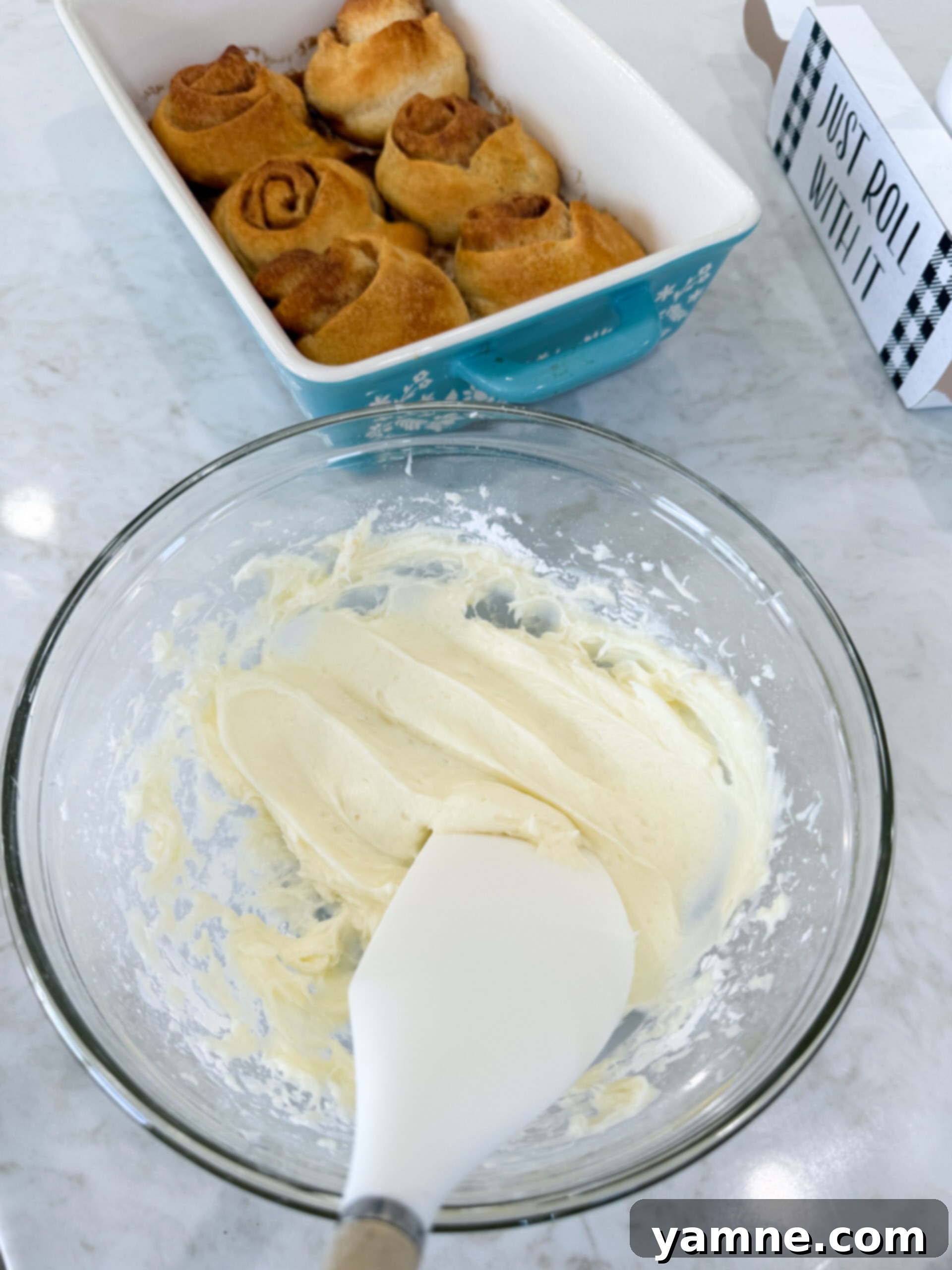 Cream cheese frosting ingredients in a mixing bowl