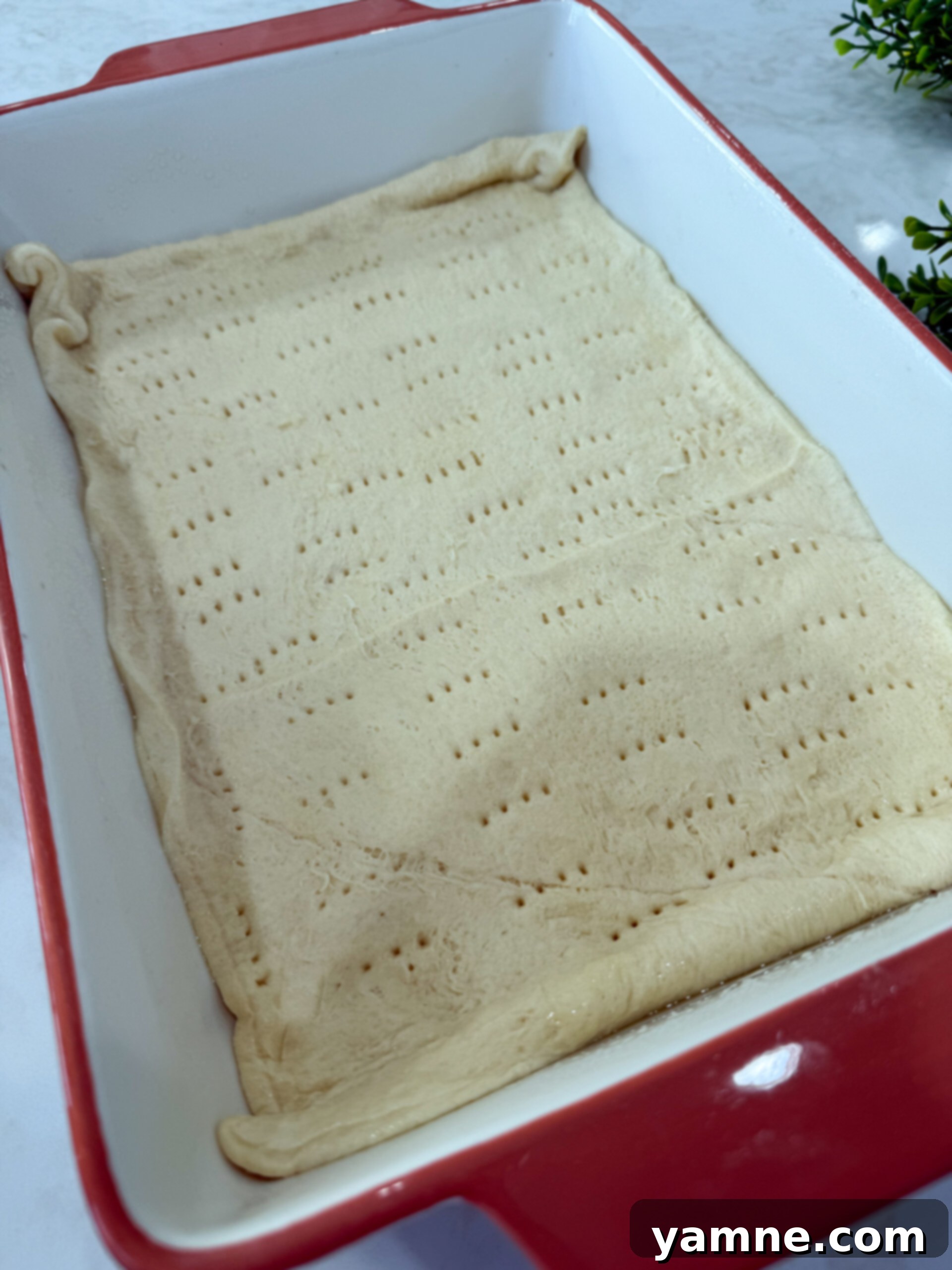 Pastrami Swirl Bake 5 Laying crescent dough sheet in baking dish
