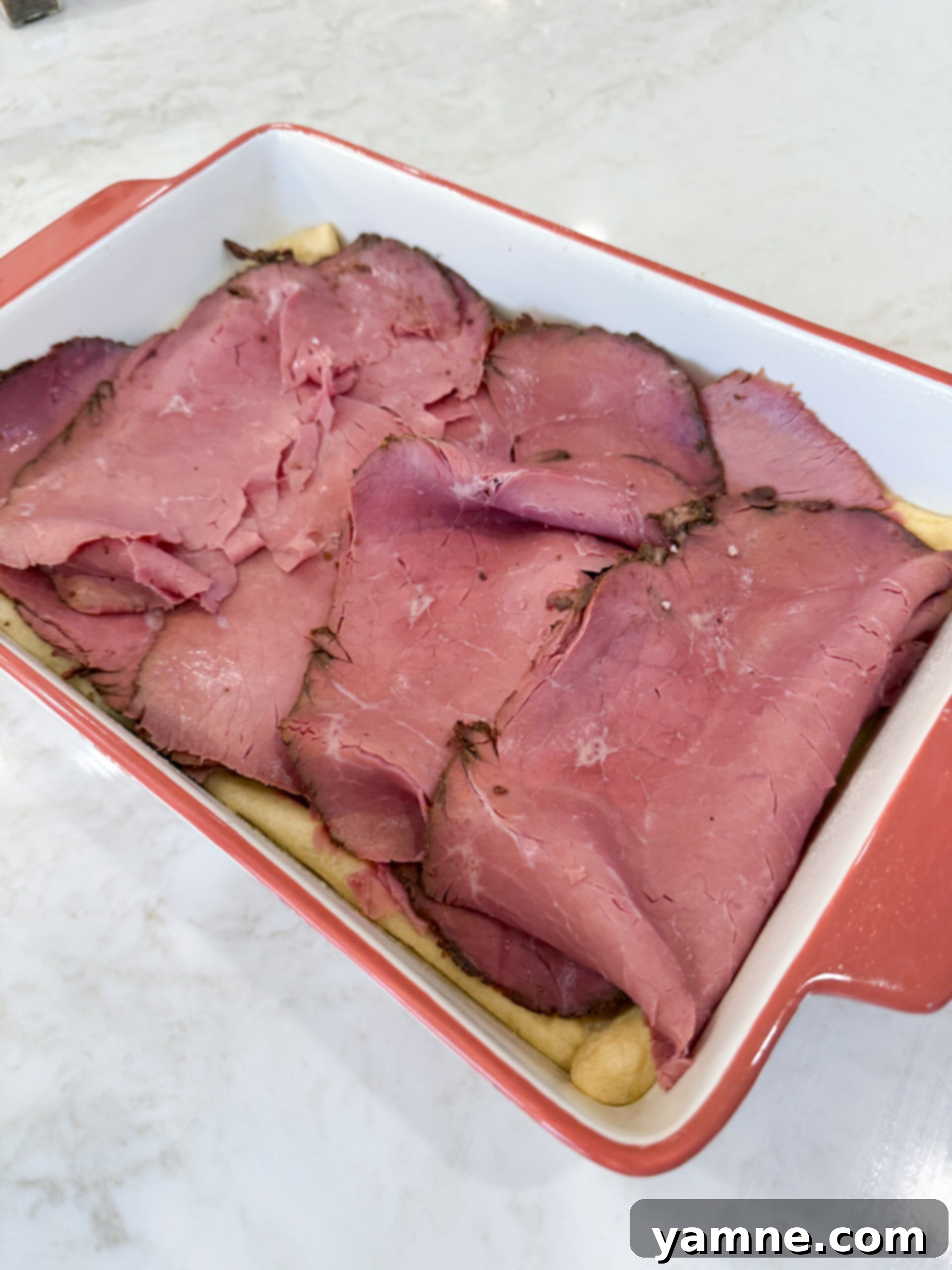 Pastrami Swirl Bake 6 Adding Swiss cheese and pastrami