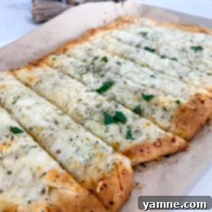 Golden baked cheesy garlic bread made with crescent dough on sheet pan
