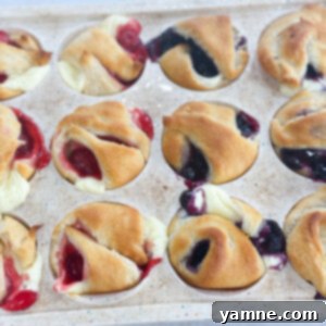Golden mini cheesecake pies topped with blueberry filling, a perfect bite-sized dessert.
