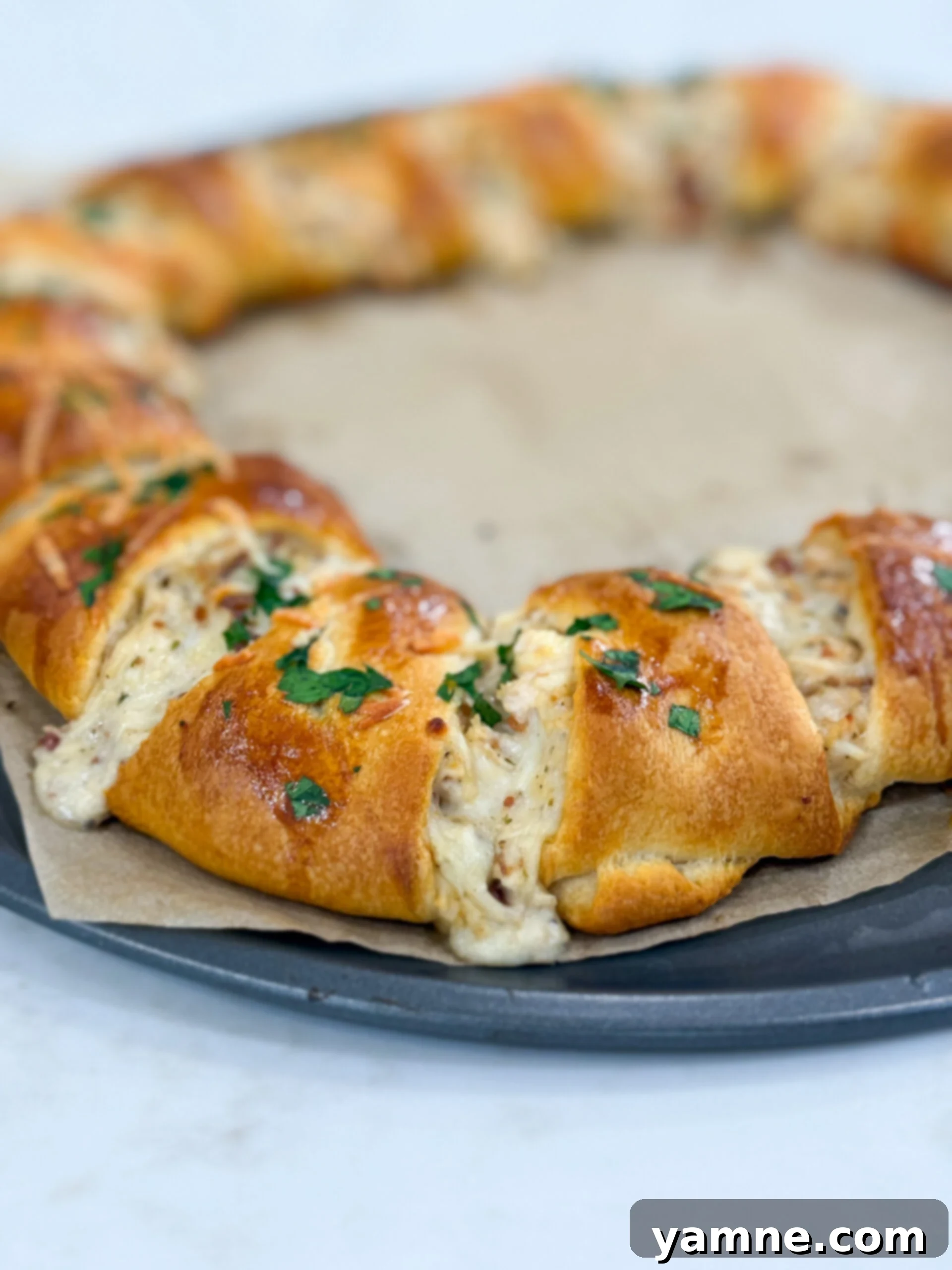 The fully assembled crescent ring, brushed with egg wash, before baking to a golden perfection.