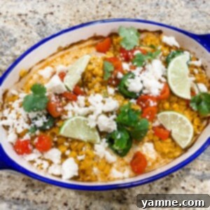 Delicious baked Street Corn Chicken topped with creamy elote-style corn