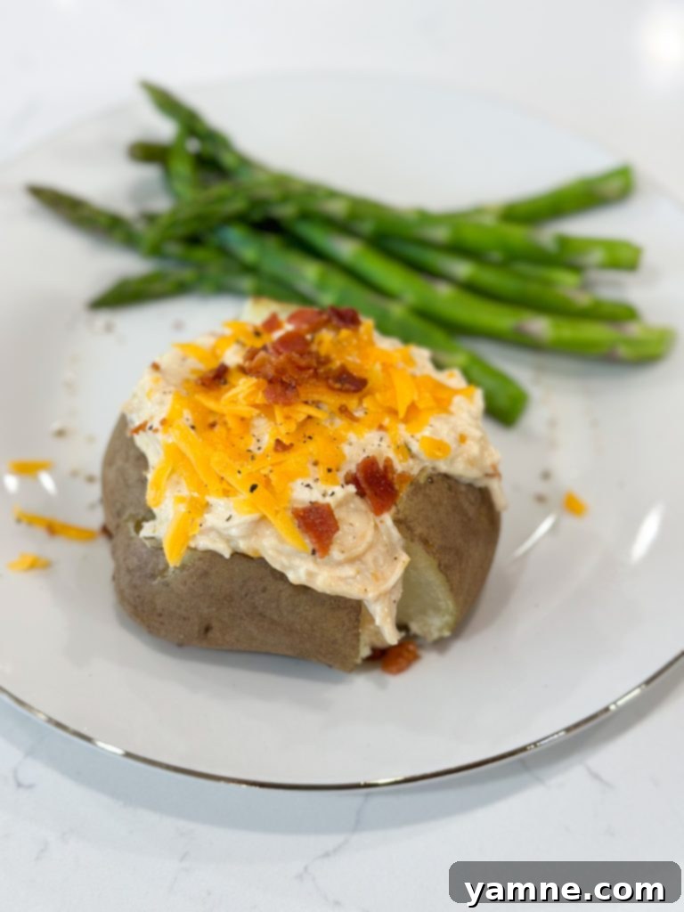 Slow cooker crack chicken served over egg noodles with bacon and green onions