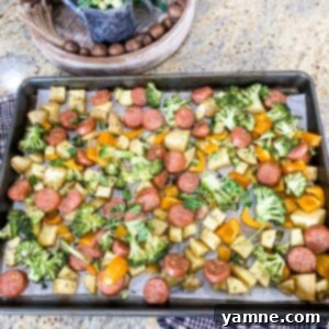 Roasted Chicken Sausage and Vegetables 2 A vibrant sheet pan featuring roasted chicken sausage, golden baby potatoes, crisp broccoli florets, and sweet orange bell pepper, fresh from the oven.