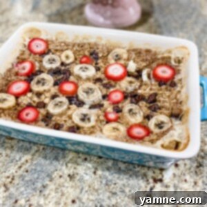 Delicious golden baked oatmeal with fresh berries and chocolate chips, ready to be served