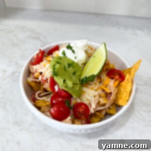 Slow Cooker Fiesta Chicken served over tortilla chips