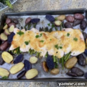 Sheet Pan Chicken Parmesan with Roasted Baby Potatoes and Asparagus 2 Crispy Sheet Pan Chicken Parmesan with Roasted Asparagus and Baby Potatoes, served as a complete meal.