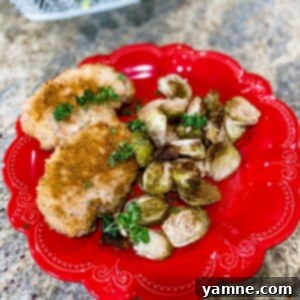 Sheet Pan Crusted Pork Chops and Brussel Sprouts on a baking sheet.