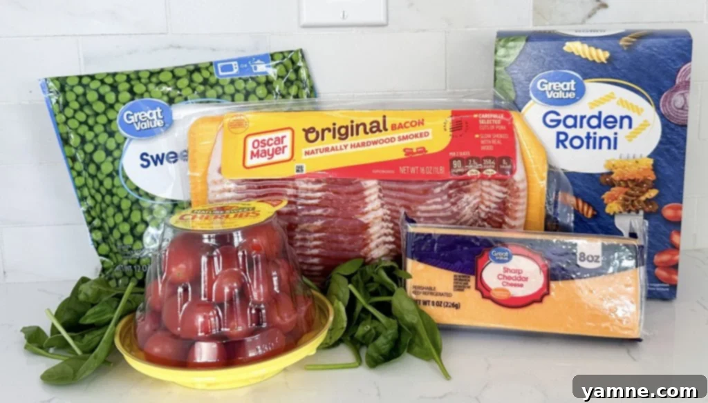 A vibrant bowl of creamy ranch bacon pasta salad with rotini, cheese, cherry tomatoes, and green onions, perfect for summer barbecues.