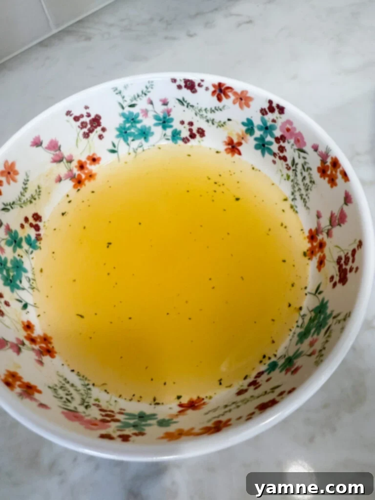 Mixing chicken broth and lemon juice for the base sauce