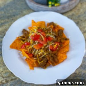 Delicious Dorito Pie with ground beef, beans, cheese, and fresh tomatoes
