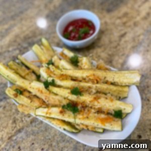Crispy Parmesan Crusted Zucchini Quarters on a baking sheet