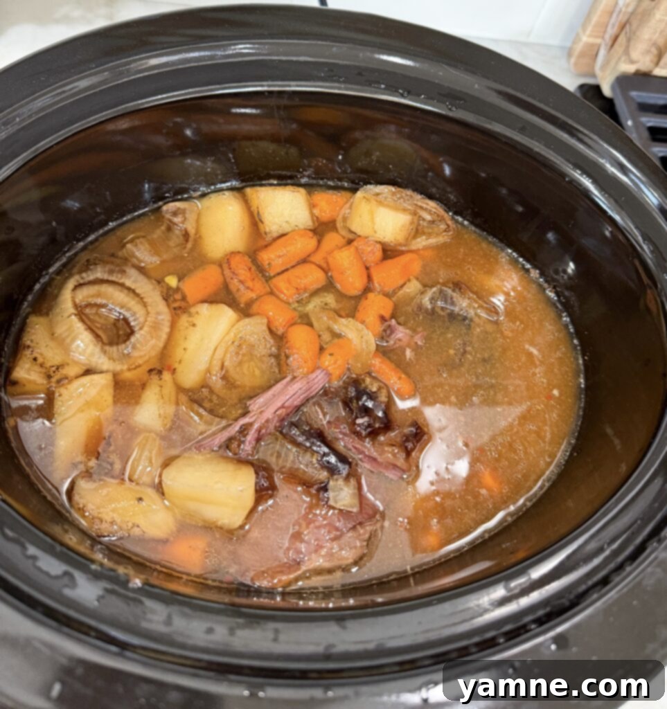 Perfect Slow Cooker Pot Roast 5 A slow cooker with its lid securely on, gently cooking a pot roast inside