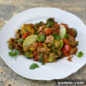 A vibrant Turkey Veggie Skillet with ground turkey, zucchini, bell pepper, and broccoli, topped with melted cheese.