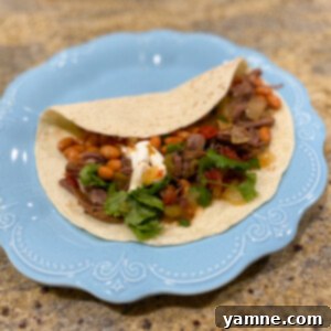 Tender and flavorful Crockpot Carne Asada, shredded and ready for tacos.