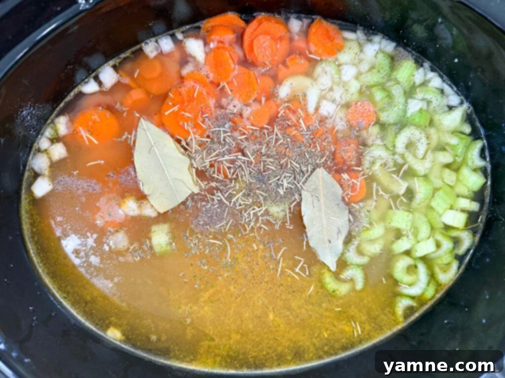 Vegetables and chicken in slow cooker before cooking