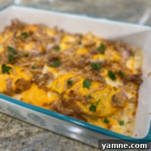 Hearty Pork and Potato Bake 2 Hearty Pork Chop and Potato Casserole with creamy sauce and golden-brown top, ready to serve.