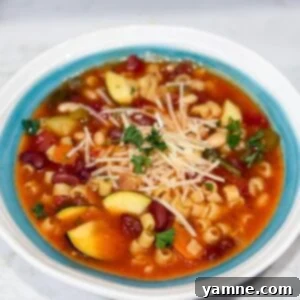Slow cooker minestrone soup in bowl with Parmesan