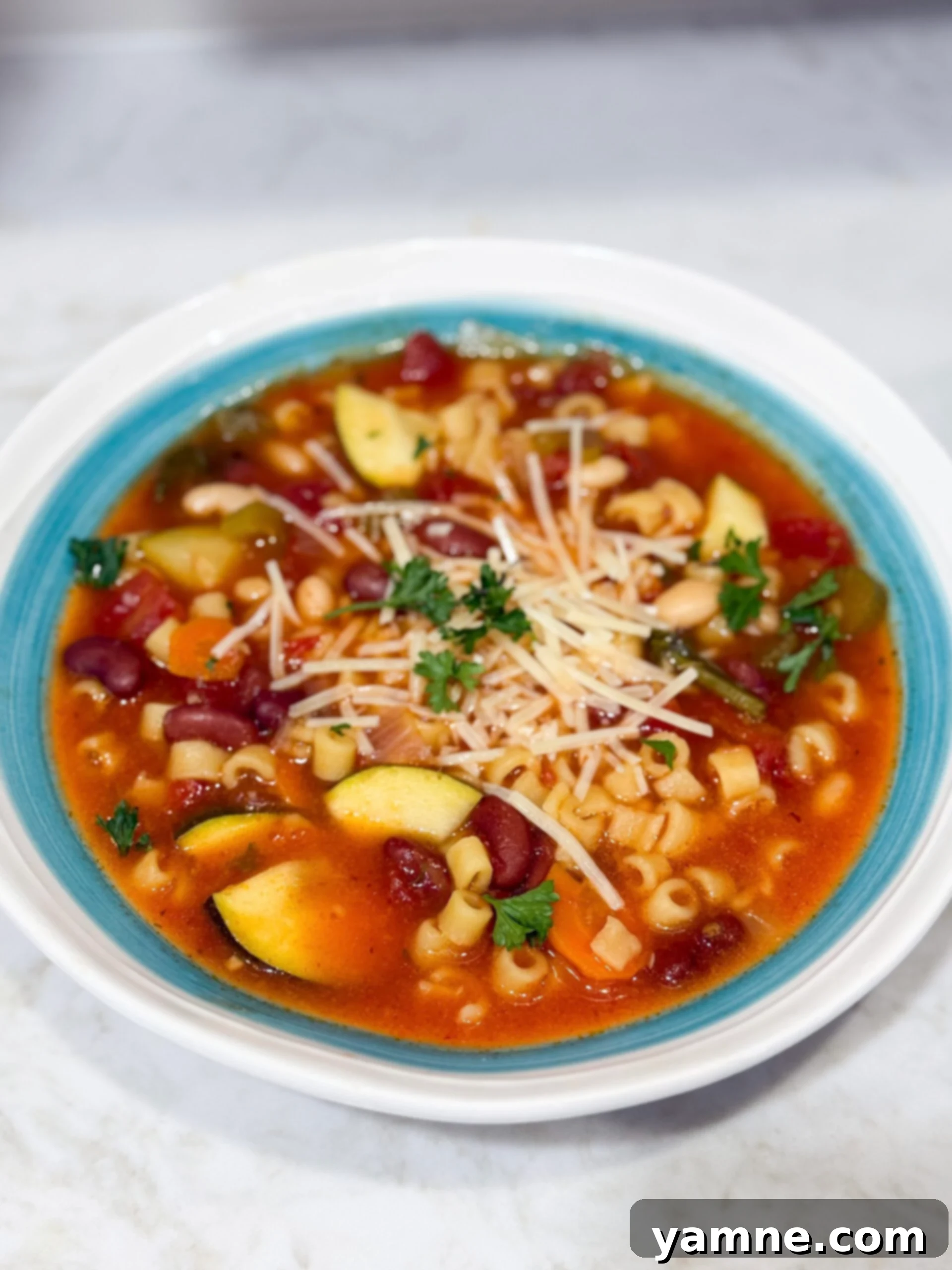 Slow cooker minestrone soup in bowl with Parmesan