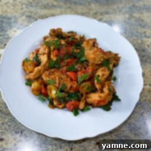 Delicious One-Pot Italian Chicken cooked in a skillet with tomatoes and spinach